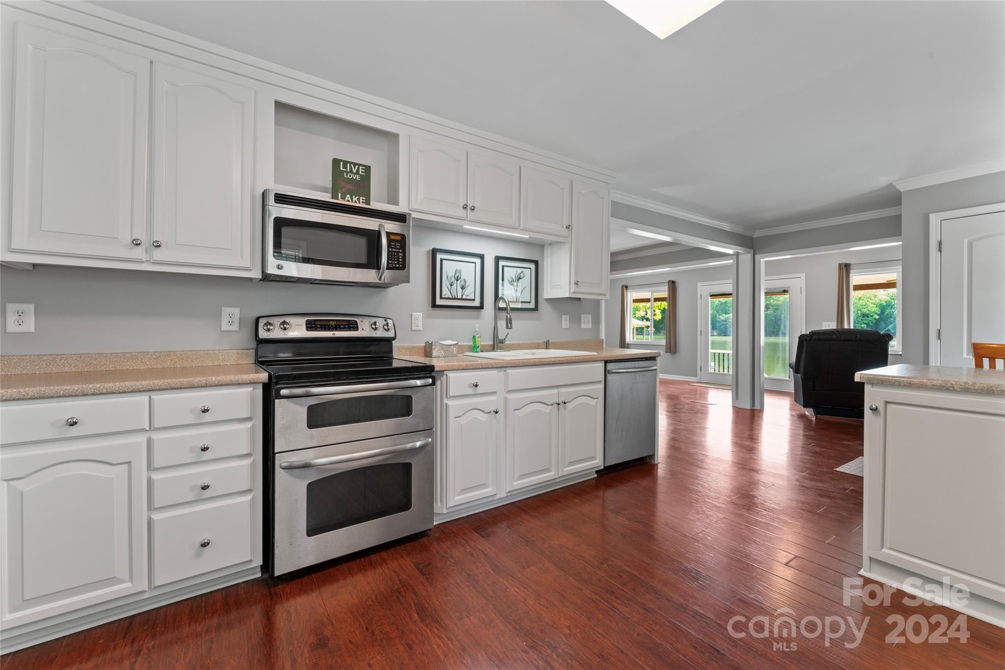 1270 Pole Branch Road Clover, SC 29710 - Photo 11 of 41 a kitchen with cabinets stainless steel appliances and wooden floor