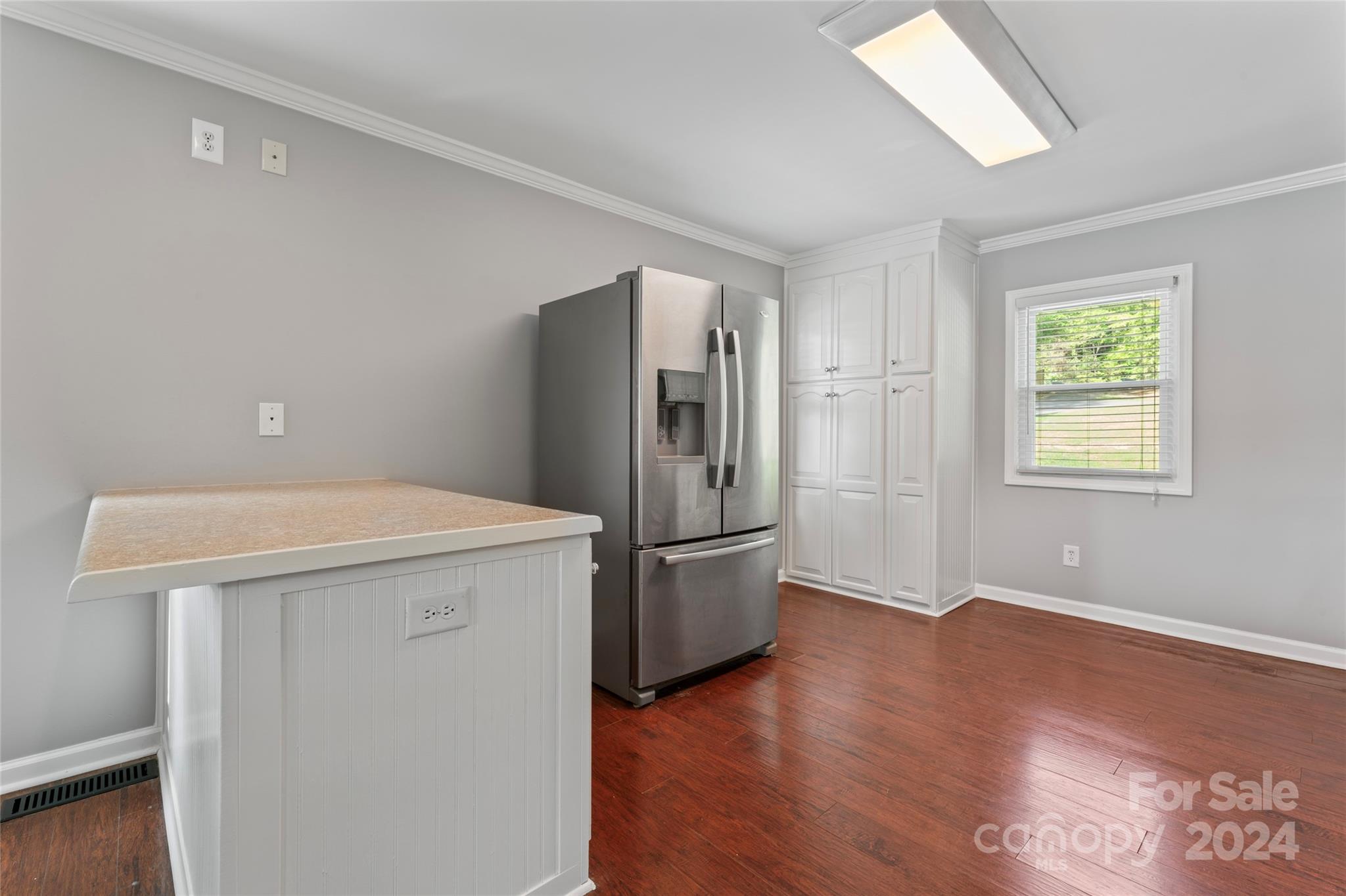 1270 Pole Branch Road Clover, SC 29710 - Photo 12 of 41 a kitchen with a refrigerator a stove top oven a wooden floor and a window
