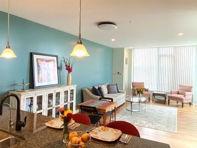 a living room with furniture a window and a dining table