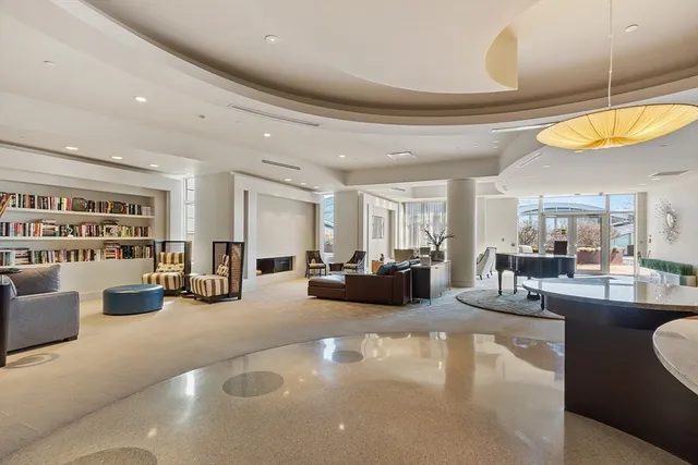a living room with furniture and kitchen view