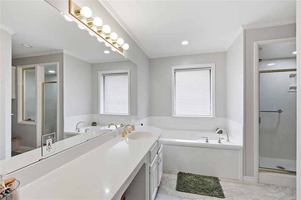 820 Toribrooke Athens, TX 75751 - Photo 12 of 23 a bathroom with a tub a sink and a large mirror