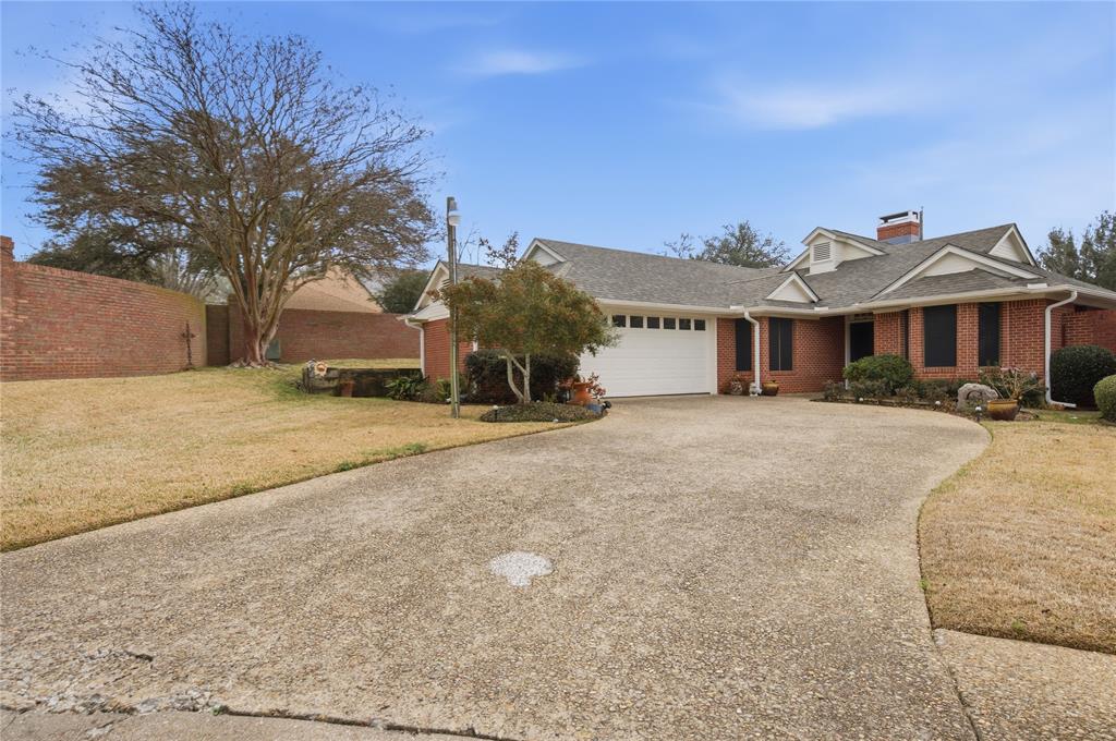 820 Toribrooke Athens, TX 75751 - Photo 23 of 23 a view of a white house next to a yard with a fountain and large trees