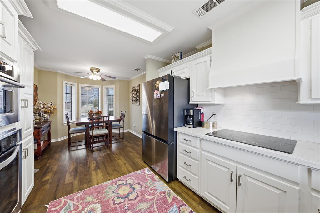 820 Toribrooke Athens, TX 75751 - Photo 8 of 23 a kitchen with white cabinets and stainless steel appliances