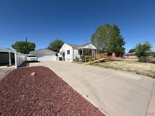 a view of a house with outdoor space and street view