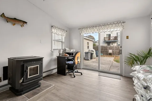 a view of a livingroom with workspace and a window