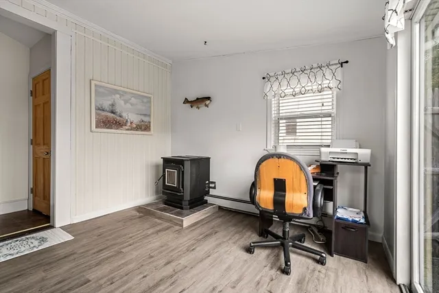 a view of a workspace with furniture and a window