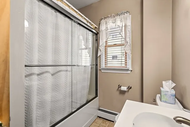 a bathroom with a bathtub and a shower