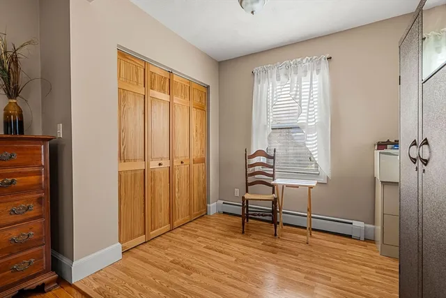 a view of room with window and wooden floor