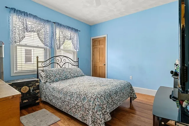 a bedroom with a bed and windows