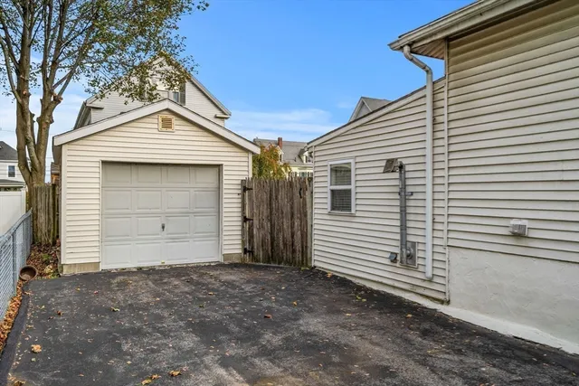 a view of a white house with a small space