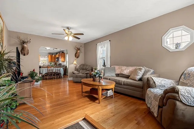 a living room with furniture a chandelier and a flat screen tv