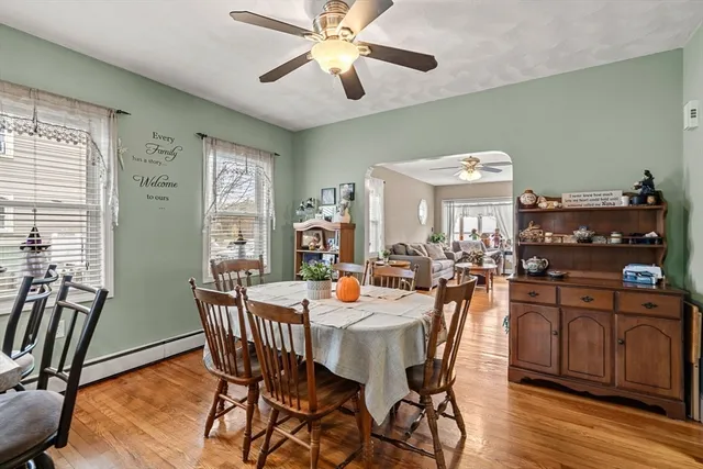 a dining room with furniture a window and wooden floor