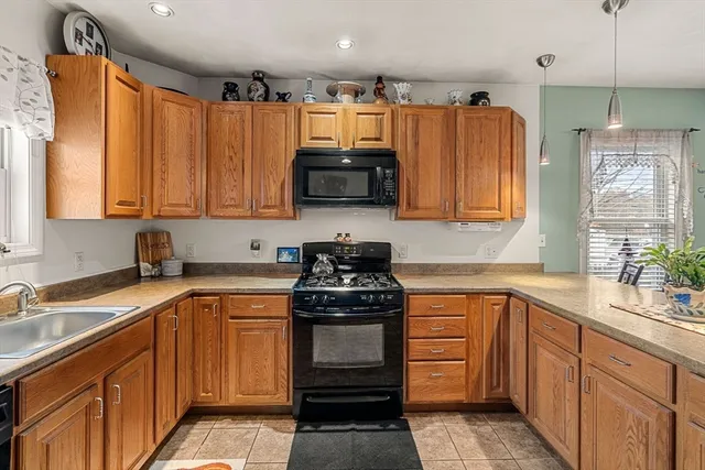 a kitchen with stainless steel appliances a stove sink and cabinets