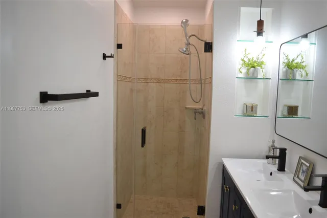 a bathroom with a sink a shower and a mirror
