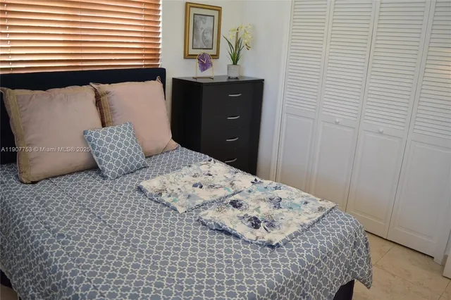 a bedroom with a bed and a mirror