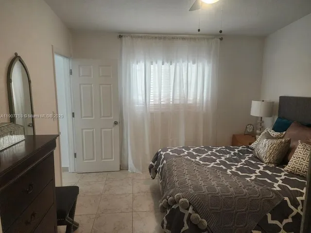 a bedroom with a bed and a mirror