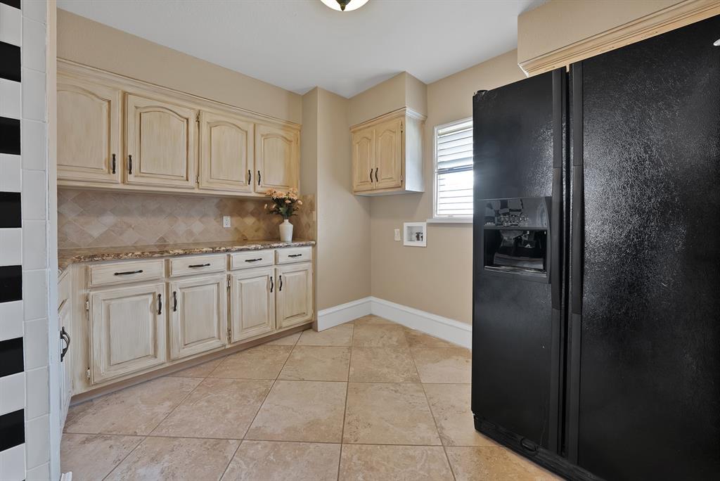 1110 McCampbell Road Mansfield, TX 76063 - Photo 23 of 39 a kitchen with white cabinets and refrigerator