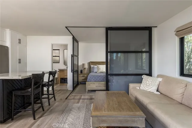 a kitchen with stainless steel appliances granite countertop a table chairs stove and white cabinets