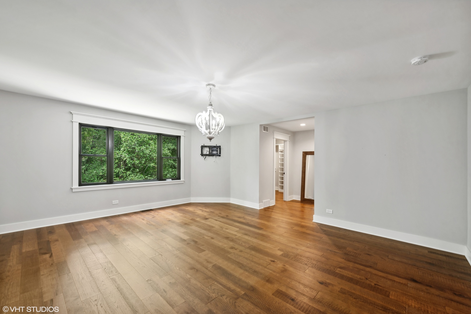268 Stonegate Road Cary, IL 60013 - Photo 11 of 35 a view of an empty room with wooden floor and a window