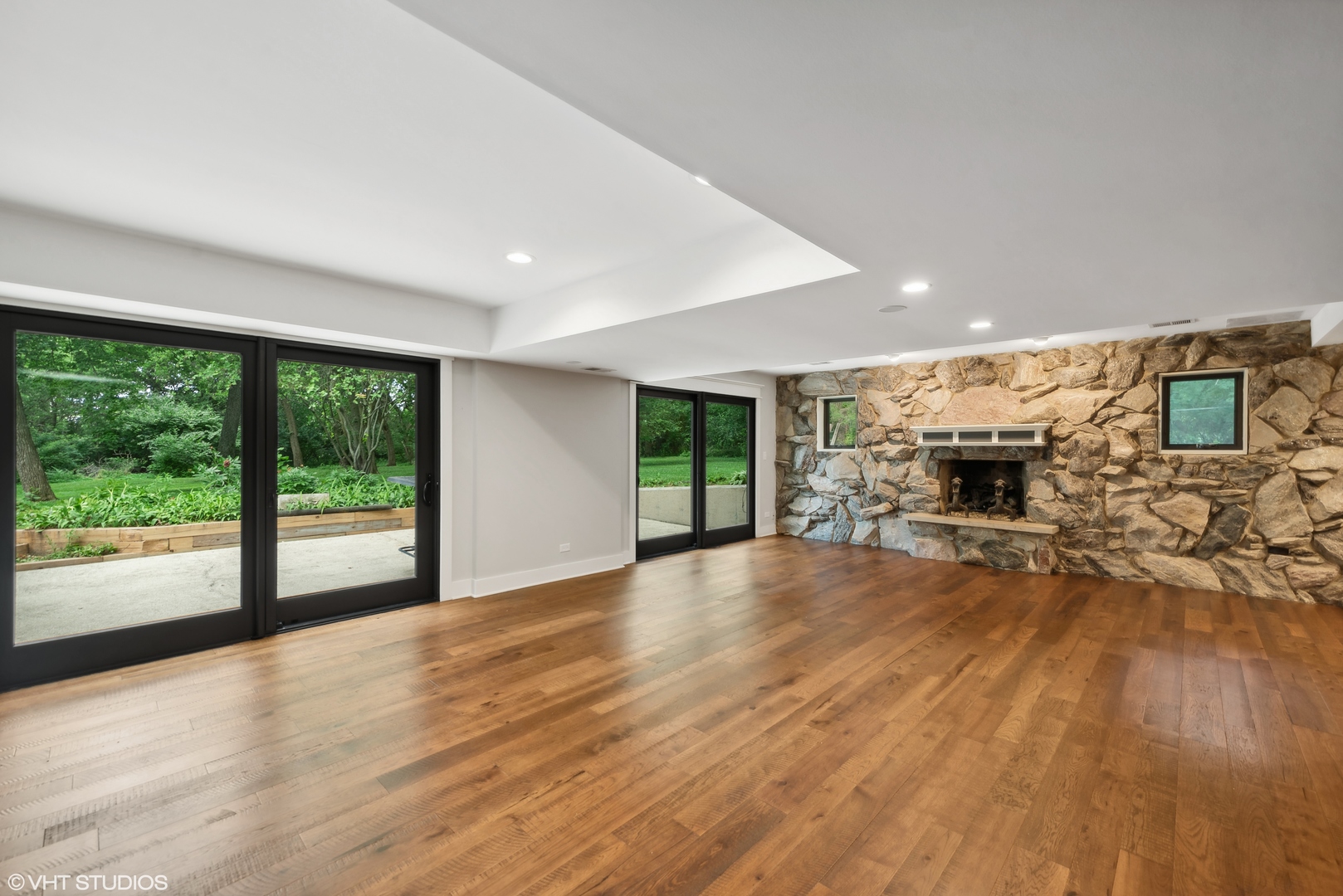 268 Stonegate Road Cary, IL 60013 - Photo 13 of 35 a view of empty room with wooden floor and fireplace