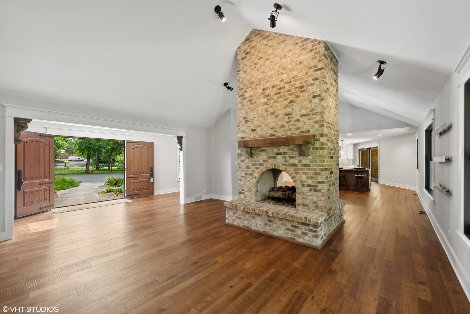 268 Stonegate Road Cary, IL 60013 - Photo 4 of 35 wooden floor fireplace and natural light in living room