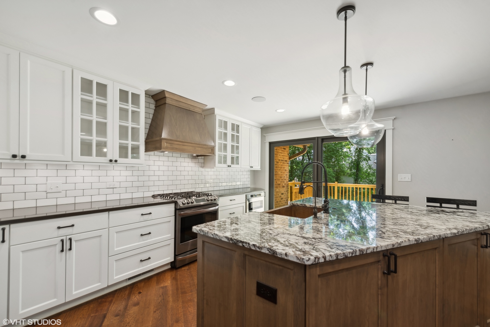 268 Stonegate Road Cary, IL 60013 - Photo 8 of 35 a kitchen with granite countertop kitchen island stainless steel appliances a sink stove and cabinets