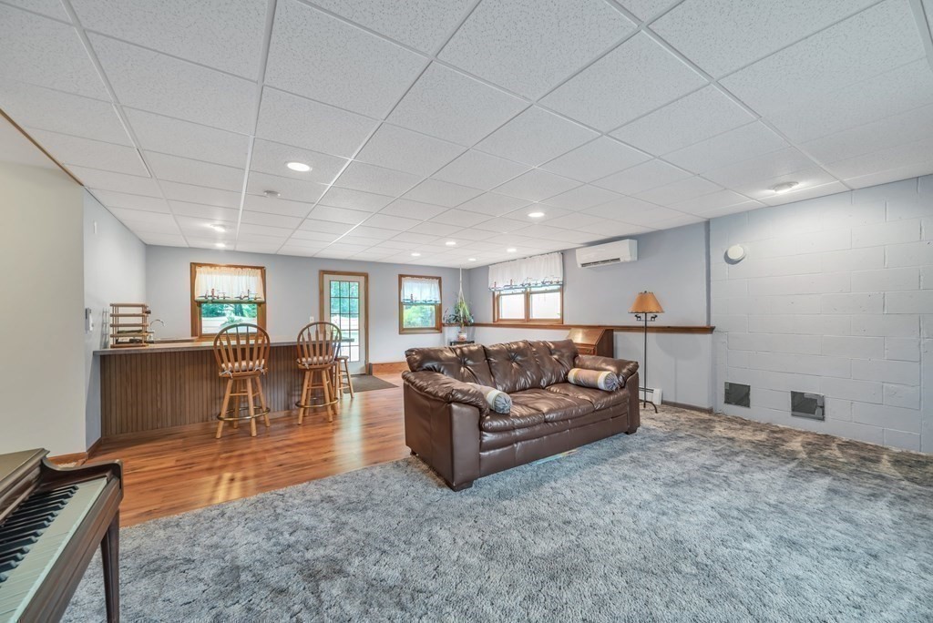 4 Stony Hill Road Hampden, MA 01036 - Photo 26 of 40 a living room with furniture and a dining table with projector view