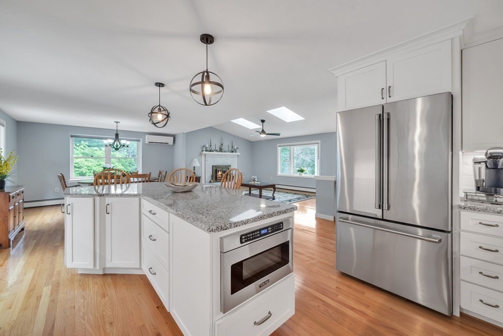 4 Stony Hill Road Hampden, MA 01036 - Photo 7 of 40 a kitchen with a center island wooden floor stainless steel appliances and window