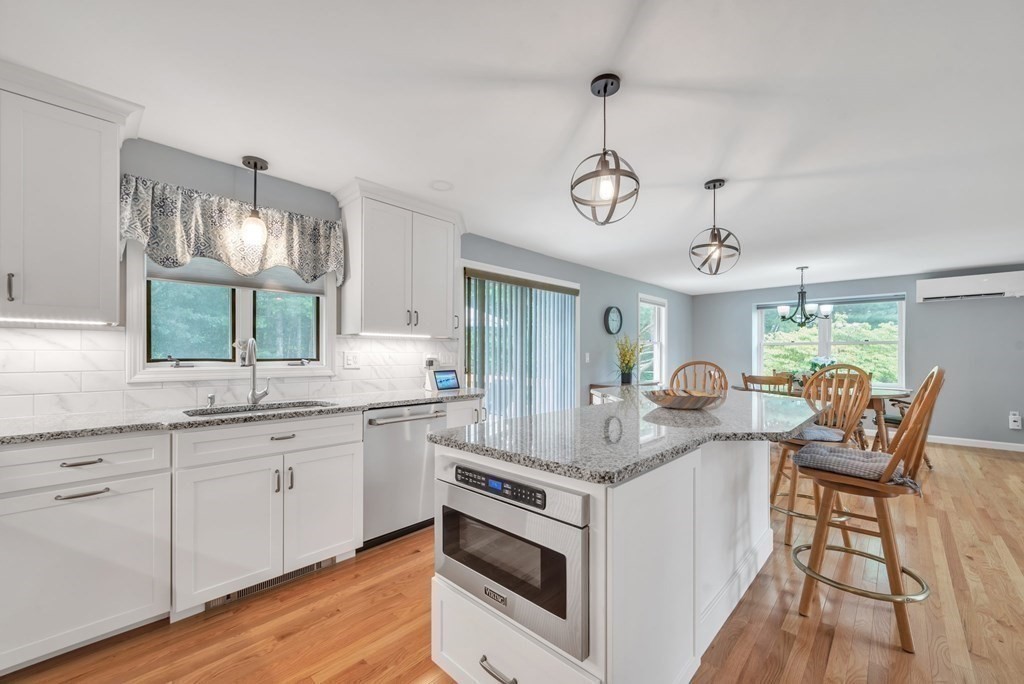 4 Stony Hill Road Hampden, MA 01036 - Photo 8 of 40 a open kitchen with stainless steel appliances granite countertop a stove and chairs with wooden floors