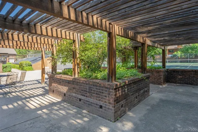 a backyard of a house with wooden floor and outdoor seating