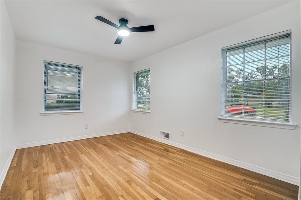 3308 Ranch Drive Garland, TX 75041 - Photo 19 of 25 a view of empty room with wooden floor and fan