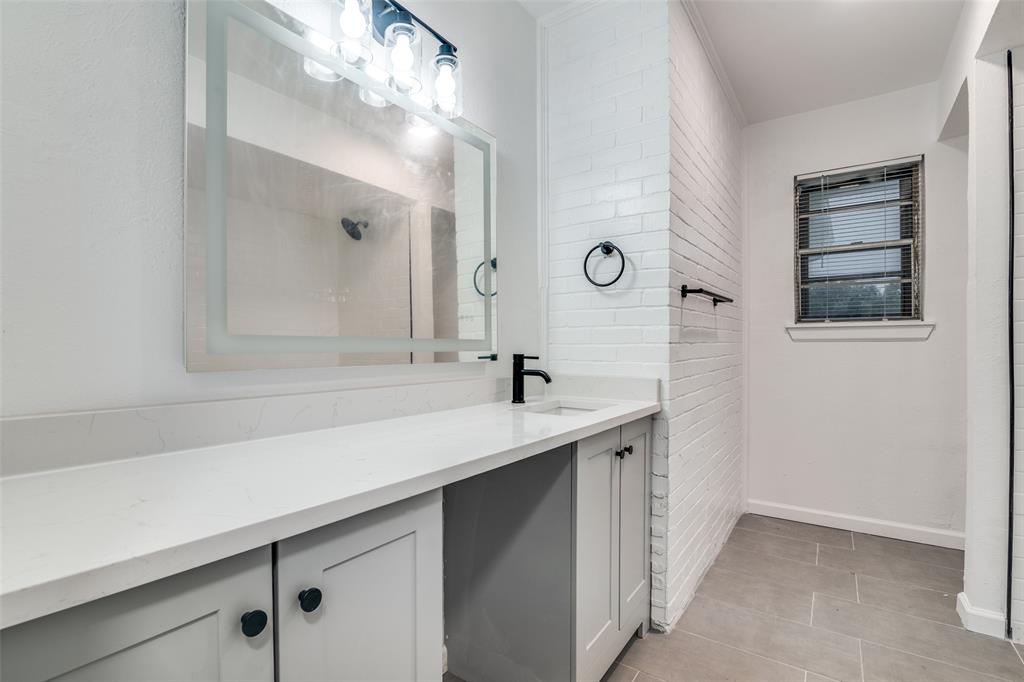 3308 Ranch Drive Garland, TX 75041 - Photo 21 of 25 a bathroom with a sink and a mirror