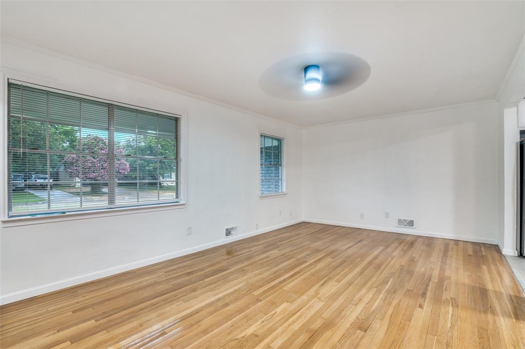 3308 Ranch Drive Garland, TX 75041 - Photo 4 of 25 a view of empty room with wooden floor and fan