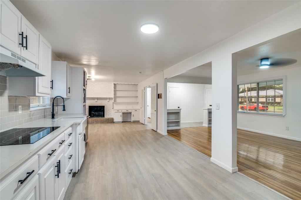 3308 Ranch Drive Garland, TX 75041 - Photo 25 of 25 a large kitchen with stainless steel appliances granite countertop a lot of counter space and wooden floor