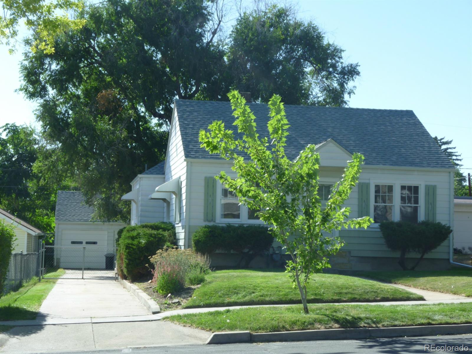 3085 Eaton Street Wheat Ridge, CO 80214 - Photo 1 of 1 a front view of a house with garden
