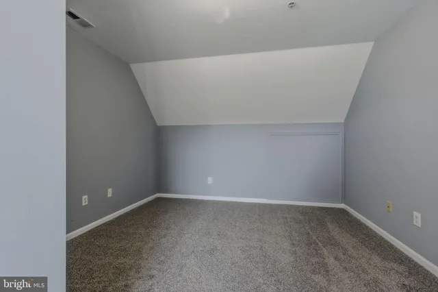 an empty room with furniture and a window