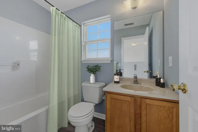 a spacious bedroom with a bed and a dresser