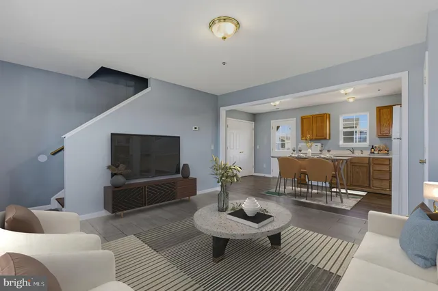 a kitchen with stainless steel appliances granite countertop a stove a sink a refrigerator a microwave oven with a dining table and chairs