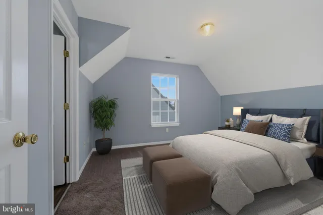 a bedroom with a large bed and a rug