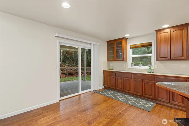 a large kitchen with granite countertop wooden cabinets a sink and dishwasher