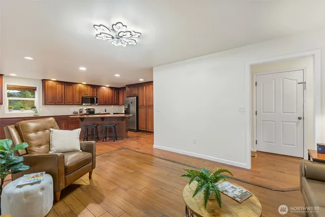 a living room with furniture and kitchen view