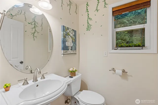 a bathroom with a sink mirror and toilet