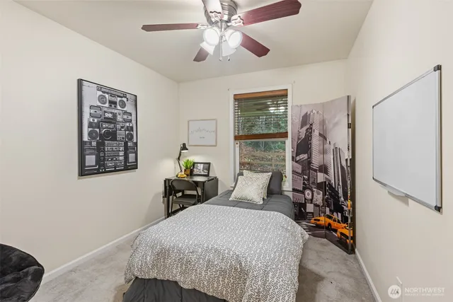 a bedroom with a bed and a chandelier