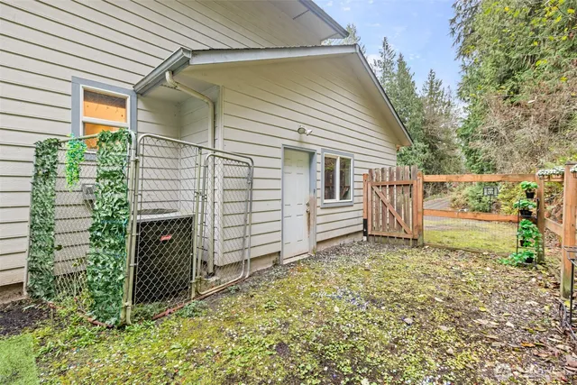 a view of a house with backyard and a fence