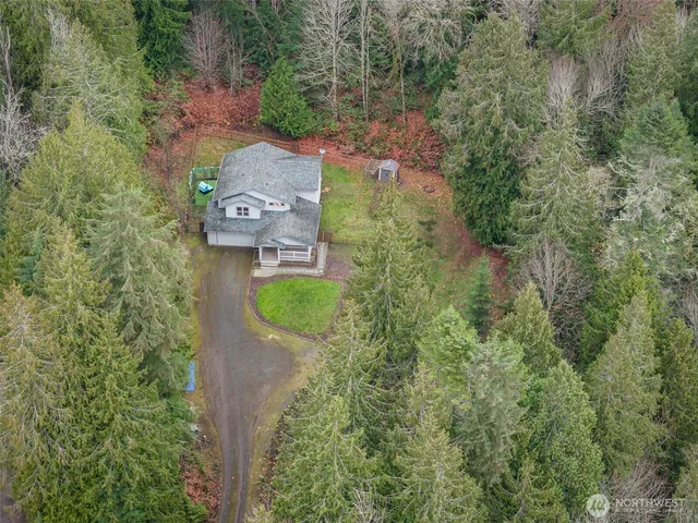 an aerial view of a house with a yard basket ball court and outdoor seating