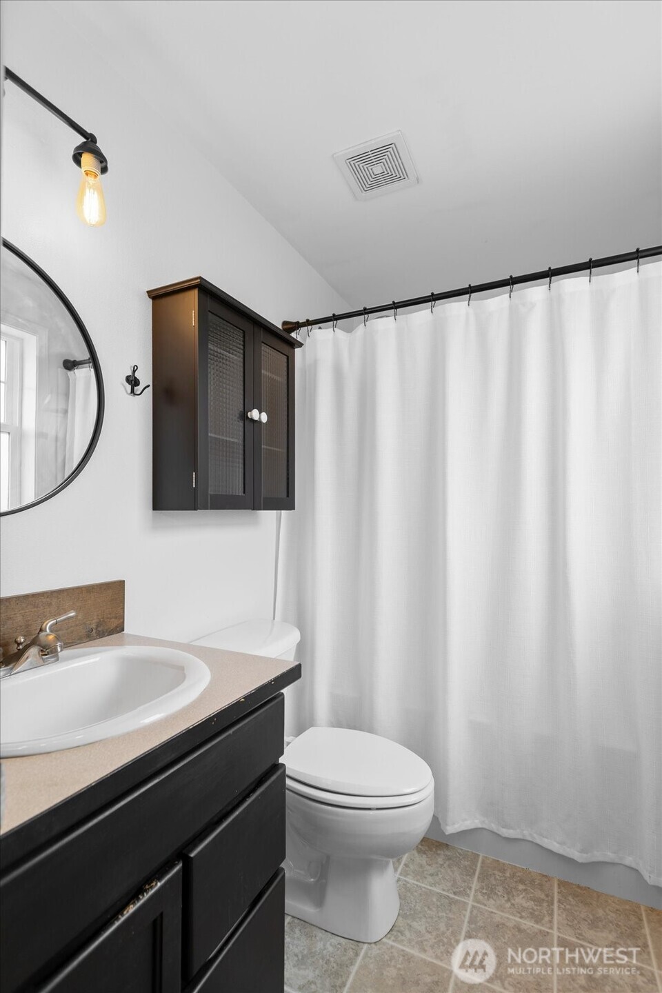 208 Shantel Street Mount Vernon, WA 98274 - Photo 17 of 31 a bathroom with a toilet a sink and a mirror