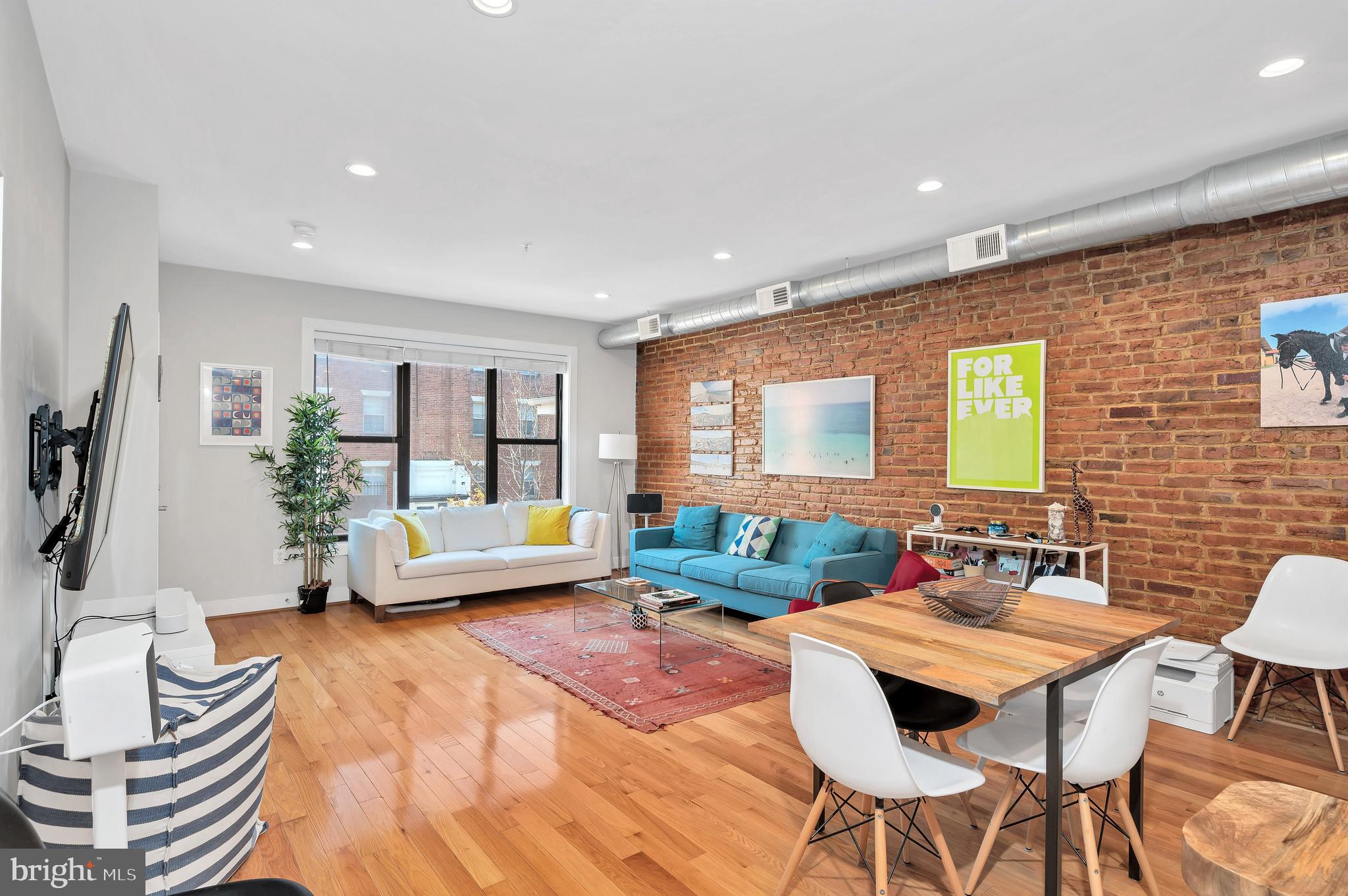 a living room with fireplace furniture and a potted plant