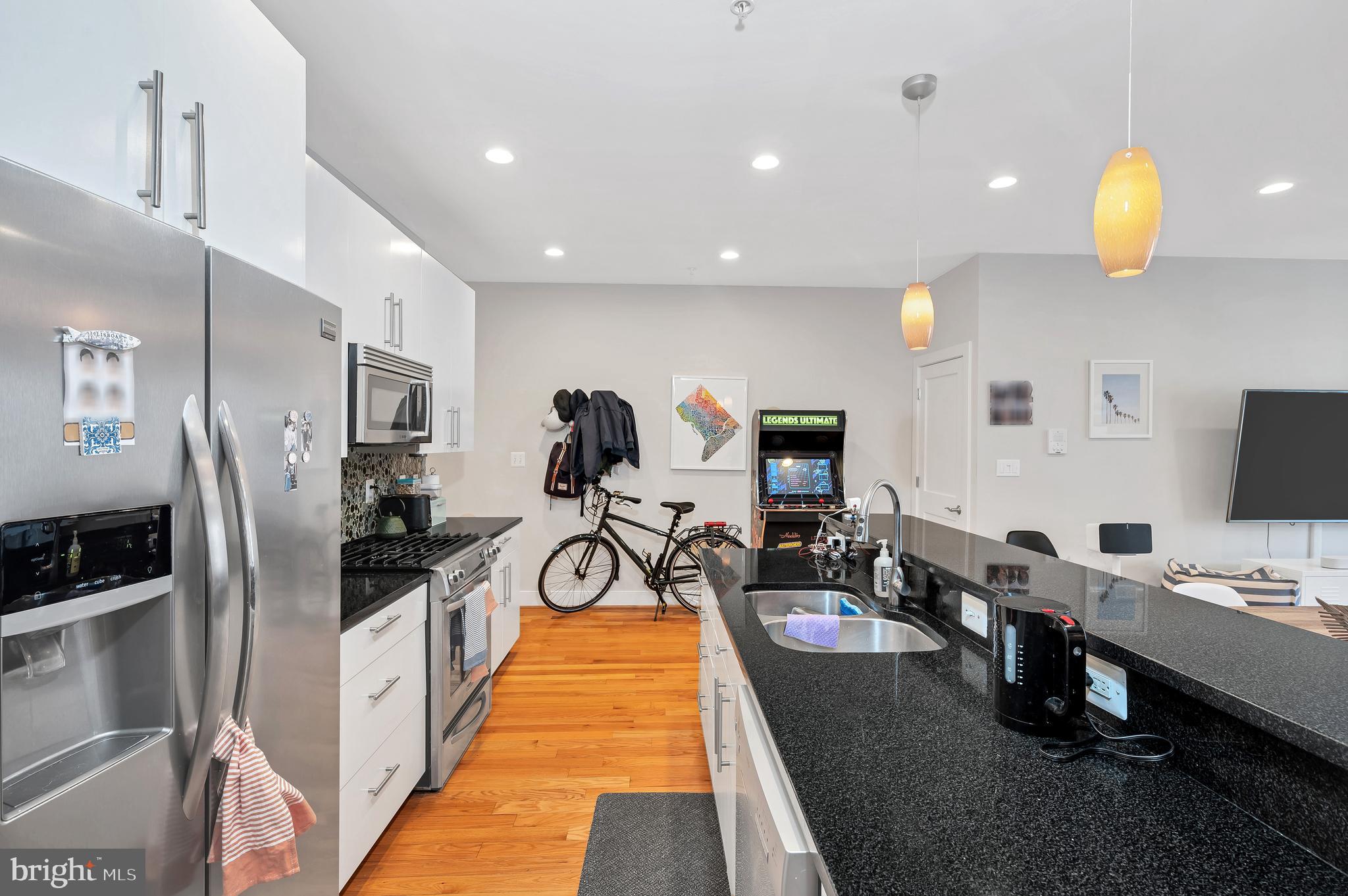 2444 Ontario Road Northwest, Unit 2 Washington, DC 20009 - Photo 11 of 29 a view of a kitchen with refrigerator and a stove