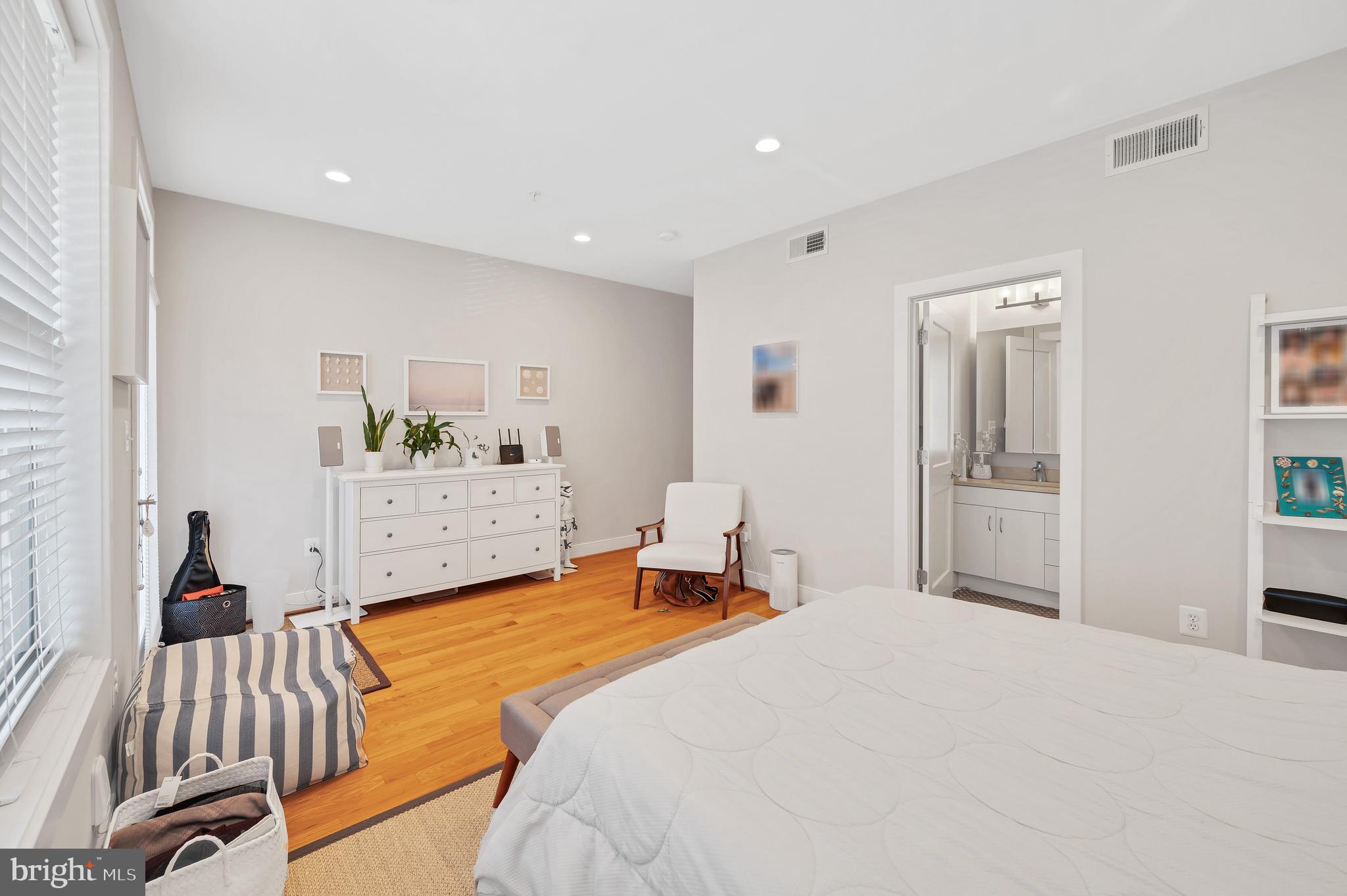 2444 Ontario Road Northwest, Unit 2 Washington, DC 20009 - Photo 13 of 29 a bedroom with a bed and a lamp on dresser