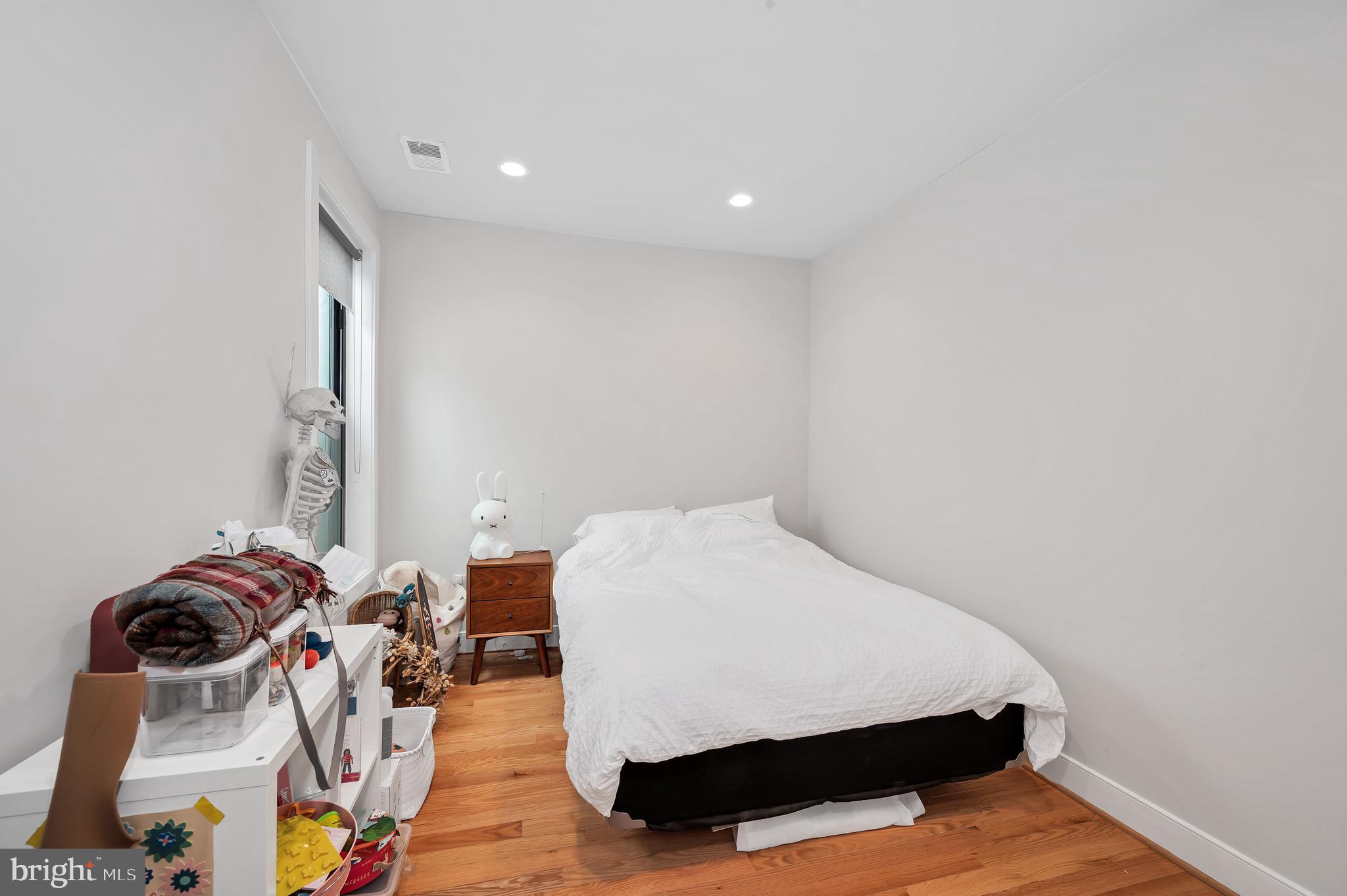 2444 Ontario Road Northwest, Unit 2 Washington, DC 20009 - Photo 19 of 29 a bedroom with a bed and wooden floor